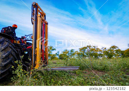 Tractor forklift in field. Agricultural machinery and equipment. 123542182
