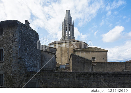 Spain, Girona - 09/18/2017: Ancient architecture of the historic part of the city and the bell tower of the Cathedral Spain, Girona - 09/18/2017: Ancient architecture of the historic part of the city and the bell tower of the Cathedral 123542639