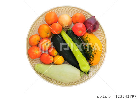 Tomatoes, zucchini, onions and hot peppers in a ceramic plate isolate on white background. Variety vegetables in rustic bowl. Top view. Tomatoes, zucchini, onions and hot peppers in a ceramic plate isolate on white background. Variety vegetables in rustic bowl. Top view. 123542797
