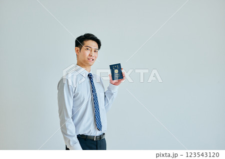 パスポートを持つ20代の若い男性 パスポートを持つ20代の若い男性 123543120