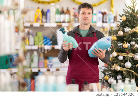 Man seller offers laundry detergent and spray 123544320