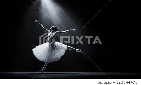 Ballerina dancing on stage with spotlight and tutu in black and white 123544475