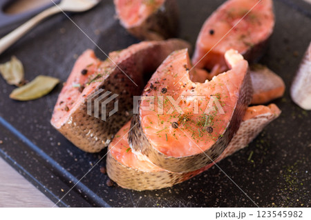 Salmon steaks with herbs and black pepper Salmon steaks with herbs and black pepper 123545982