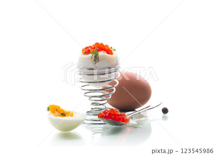 Delicacy with red caviar and boiled egg, isolated on white background 123545986