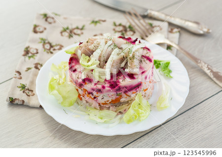 Delicious beetroot salad with herring on a served table Delicious beetroot salad with herring on a served table 123545996
