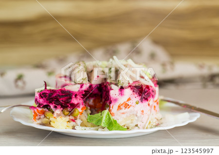 Delicious beetroot salad with herring on a served table 123545997