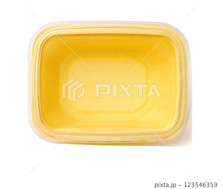 Closed plastic container full of melted butter from above 123546359