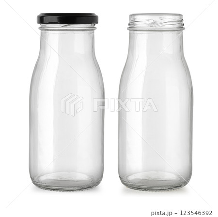 Two empty glass bottles showing open and closed with black cap Two empty glass bottles showing open and closed with black cap 123546392