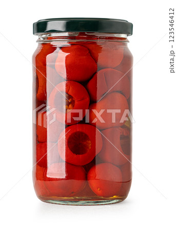 Glass jar preserving small round red peppers stuffed with filling Glass jar preserving small round red peppers stuffed with filling 123546412