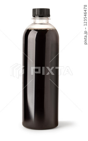 Plastic bottle containing dark liquid on white background 123546478