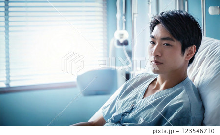 入院してベッドの中で深刻な表情の若い男性患者,generative ai_ワイド 123546710