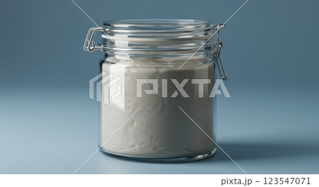 Transparent glass jar filled with flour on a blue background 123547071