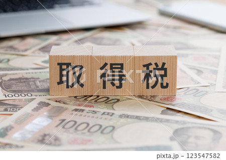 お金の上に取得税と書かれたブロック 123547582
