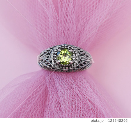Statement ring for women on a pink background, fine jewelry concept, promotional photo for an online vintage and handmade jewelry store Statement ring for women on a pink background, fine jewelry concept, promotional photo for an online vintage and handmade jewelry store 123548295