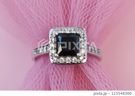 Statement ring for women on a pink background, fine jewelry concept, promotional photo for an online vintage and handmade jewelry store Statement ring for women on a pink background, fine jewelry concept, promotional photo for an online vintage and handmade jewelry store 123548300