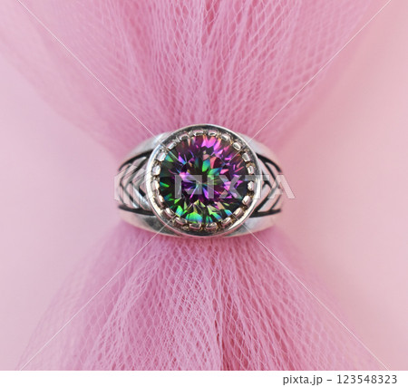 Statement ring for women on a pink background, fine jewelry concept, promotional photo for an online vintage and handmade jewelry store Statement ring for women on a pink background, fine jewelry concept, promotional photo for an online vintage and handmade jewelry store 123548323