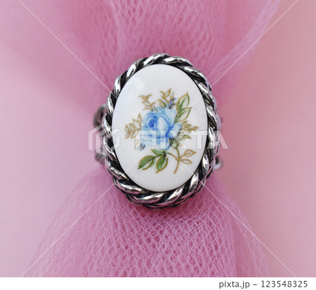 Statement ring for women on a pink background, fine jewelry concept,  promotional photo for an online vintage and handmade jewelry store Statement ring for women on a pink background, fine jewelry concept,  promotional photo for an online vintage and handmade jewelry store 123548325