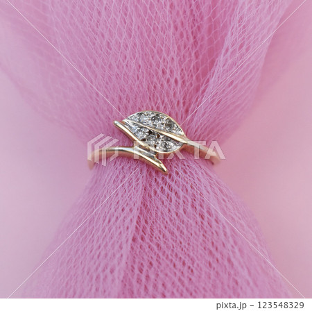 Statement ring for women on a pink background, fine jewelry concept, promotional photo for an online vintage and handmade jewelry store Statement ring for women on a pink background, fine jewelry concept, promotional photo for an online vintage and handmade jewelry store 123548329
