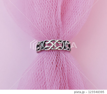 Statement ring for women on a pink background, fine jewelry concept, promotional photo for an online vintage and handmade jewelry store Statement ring for women on a pink background, fine jewelry concept, promotional photo for an online vintage and handmade jewelry store 123548395