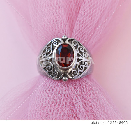 Statement ring for women on a pink background, fine jewelry concept, promotional photo for an online vintage and handmade jewelry store Statement ring for women on a pink background, fine jewelry concept, promotional photo for an online vintage and handmade jewelry store 123548403