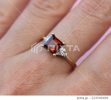 Statement ring for women on a pink background, fine jewelry concept, promotional photo for an online vintage and handmade jewelry store Statement ring for women on a pink background, fine jewelry concept, promotional photo for an online vintage and handmade jewelry store 123548404