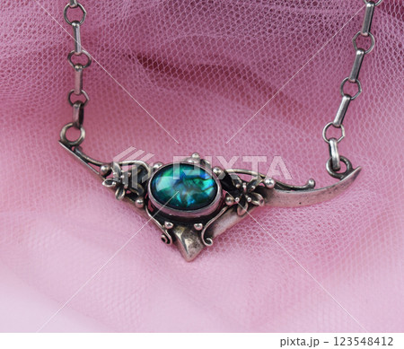 Statement necklace for women on a pink background, fine jewelry concept,  promotional photo for an online vintage and handmade jewelry store 123548412