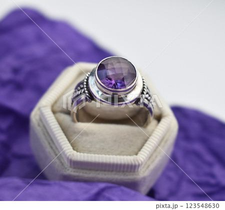 Statement ring for women on a purple background, fine jewelry concept, promotional photo for an online vintage and handmade jewelry store Statement ring for women on a purple background, fine jewelry concept, promotional photo for an online vintage and handmade jewelry store 123548630