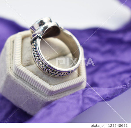 Statement ring for women on a purple background, fine jewelry concept, promotional photo for an online vintage and handmade jewelry store Statement ring for women on a purple background, fine jewelry concept, promotional photo for an online vintage and handmade jewelry store 123548631