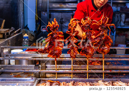 Fried oily cooked calamari at the night seafood cuisine street downtown market, Xian, Shaanxi province, China Fried oily cooked calamari at the night seafood cuisine street downtown market, Xian, Shaanxi province, China 123548925