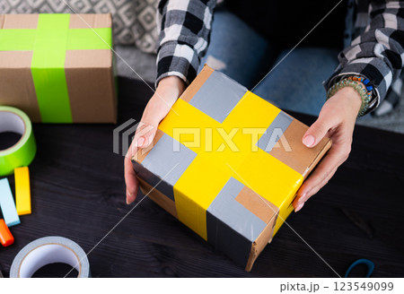 Girl Packing Cardboard Box At Home 123549099