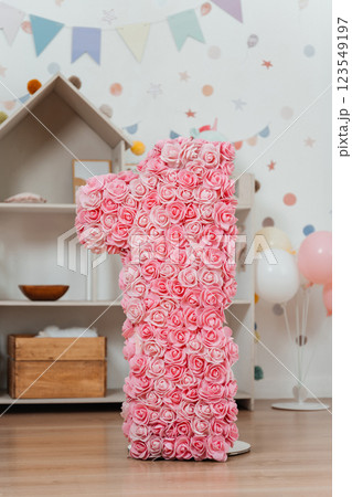 number one with pink flowers on background the playroom. photo zone for the child's first birthday number one with pink flowers on background the playroom. photo zone for the child's first birthday 123549197