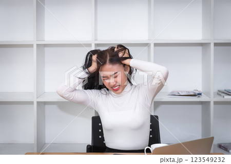 Furious and frustrated asian woman steaming and pulling her hair. Furious and frustrated asian woman steaming and pulling her hair. 123549232