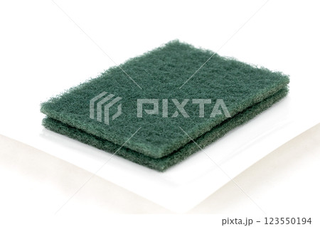 Rectangular green fiber scrubbing pad used for cleaning. 123550194
