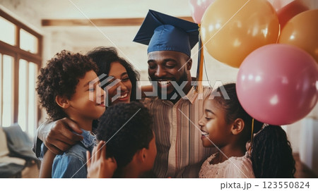 Proud family celebrating a graduate's achievement with hugs, smiles, and festive decor in a cozy home setting, capturing joy and support. 123550824