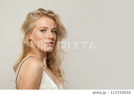 Attractive blond model woman portrait. Beautiful face with healthy clear skin, long shiny hair  123550838