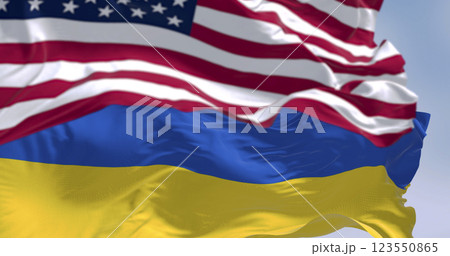 Close-up of Ukraine and US national flags waving on a clear day 123550865
