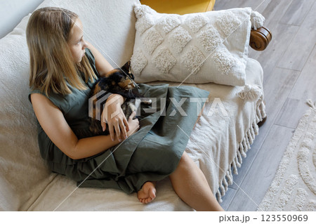 Cat and child resting indoor together 123550969