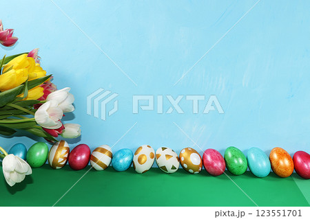 Decorated golden eggs on a trendy blue background. Minimal holiday concept. Happy Easter background, place for text, postcard, banner for the screen. 123551701