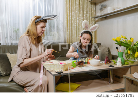 Mother And Daughter Decorating Easter Eggs At Home. 123551785