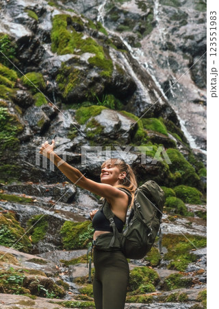 Woman Tourist Taking Selfie Picture near Waterfall 123551983