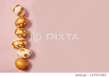 Decorated golden easter eggs on a pink background. Minimal holiday concept. Happy easter background. Creative painting of eggs at home. Decorated golden easter eggs on a pink background. Minimal holiday concept. Happy easter background. Creative painting of eggs at home. 123551985