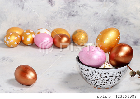 Happy Easter concept, spring greeting card, composition with gold decorated eggs on a delicate background. Minimal holiday concept, space for text, banner for screen, selective focus Happy Easter concept, spring greeting card, composition with gold decorated eggs on a delicate background. Minimal holiday concept, space for text, banner for screen, selective focus 123551988