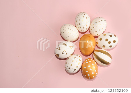 Decorated golden easter eggs on a yellow background. Minimal holiday co 123552109