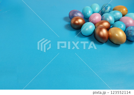Decorated golden easter eggs on trendy blue background. Minimal holiday concept. Happy Easter background, place for text, postcard, banner for the screen. Decorated golden easter eggs on trendy blue background. Minimal holiday concept. Happy Easter background, place for text, postcard, banner for the screen. 123552114