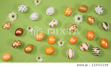 Decorated golden and blue eggs on a trendy green background. Minimal holiday concept. Happy Easter background, pattern, greeting card, banner for the screen. Decorated golden and blue eggs on a trendy green background. Minimal holiday concept. Happy Easter background, pattern, greeting card, banner for the screen. 123552149
