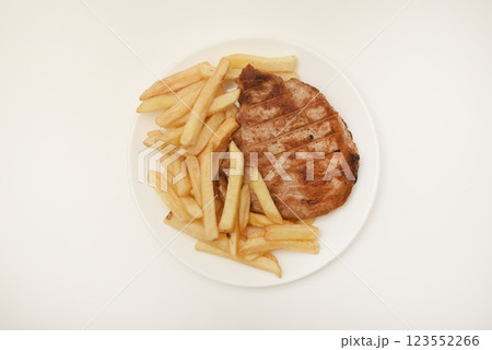Roast pork loin with fried potatoes. Delicious meat breakfast. French fries. Roast pork loin with fried potatoes. Delicious meat breakfast. French fries. 123552266