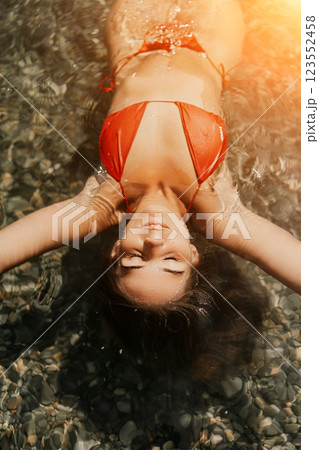 Happy woman sea relaxing floating in transparent sea water on summer holiday. Travel leisure recreation lifestyle, female in nature. 123552458