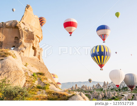 Colorful hot air balloons flying over rock landscape at Cappadocia Turkey 123552719