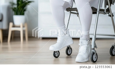 Woman stands with crutches in a bright room, wearing a boot on her left leg, showcasing a realistic home care moment 123553061