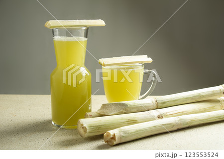 two glasses of sugar cane juice drink on white marble table isolated 123553524